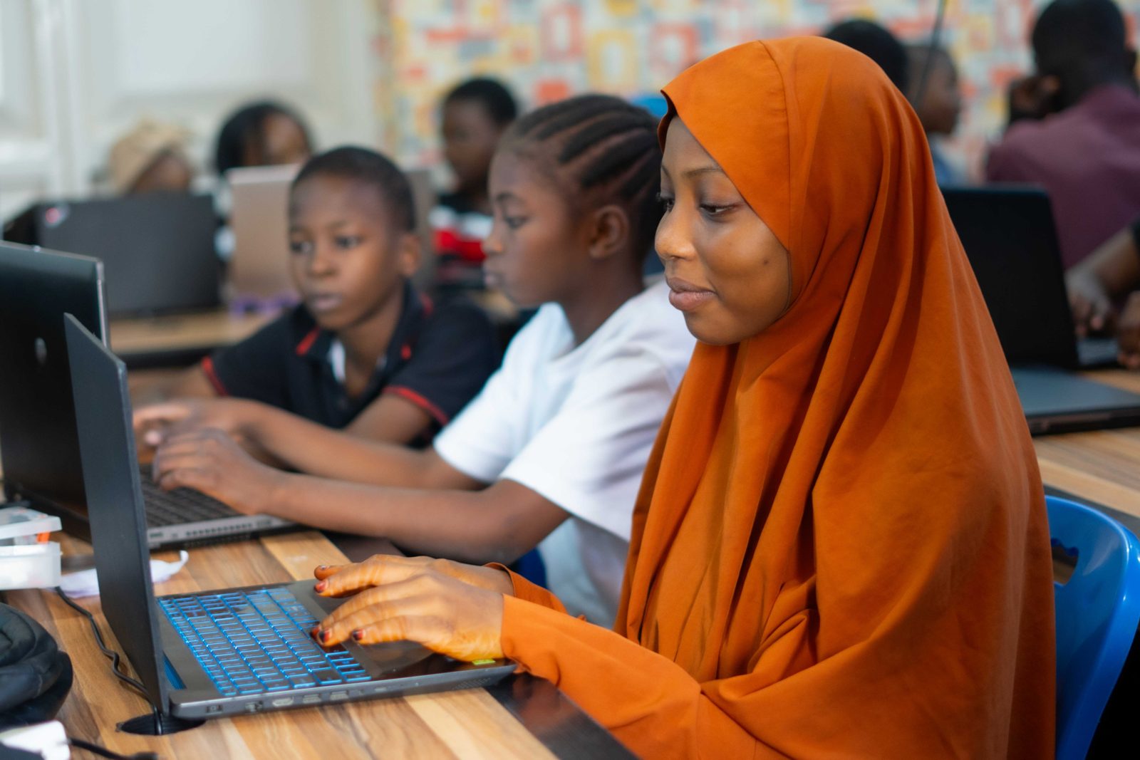 Student focused on writing code on a laptop